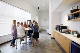 People conversing in a break room.