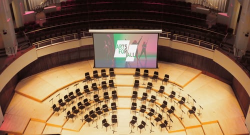 a projection screen hanging in the Clarice Performing Arts Center