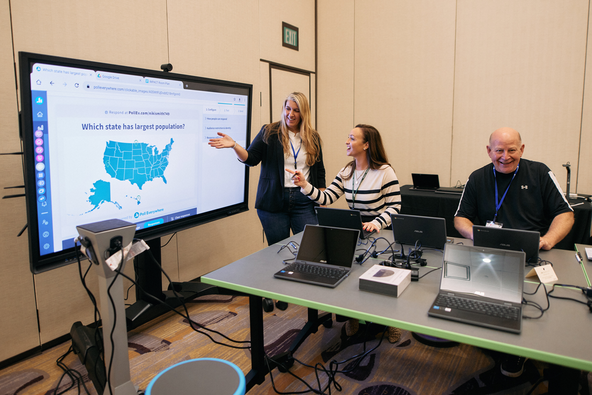 Woman teaching other adults how to use technology