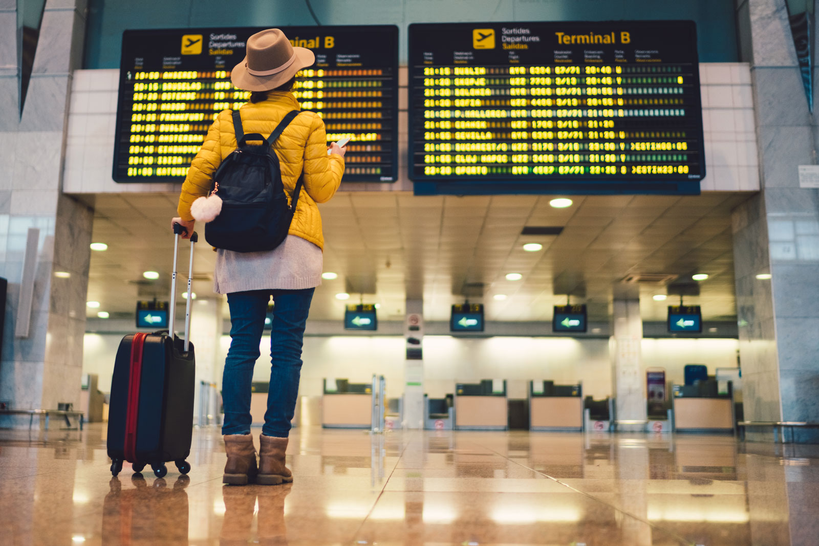 person looking at digital signage at airport