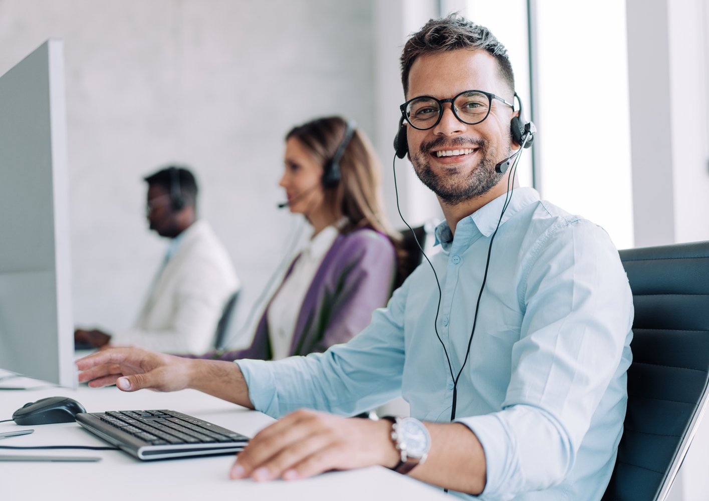 Guy with headphones on at a computer