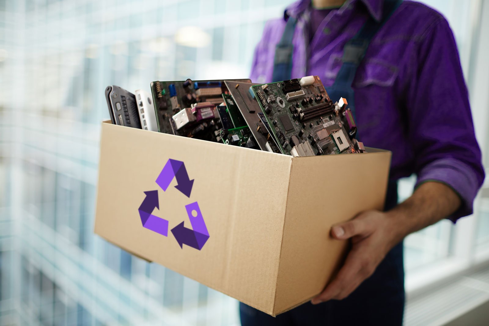 person holding a recycling box with old technology